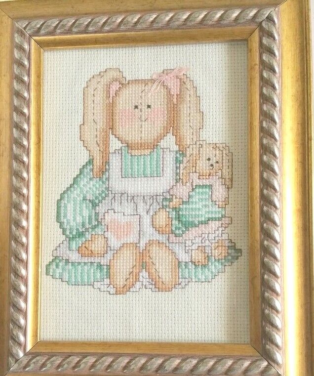 Cross stitch Little Girl  in a Pinafore  picture With Pony Tails Holding a Do