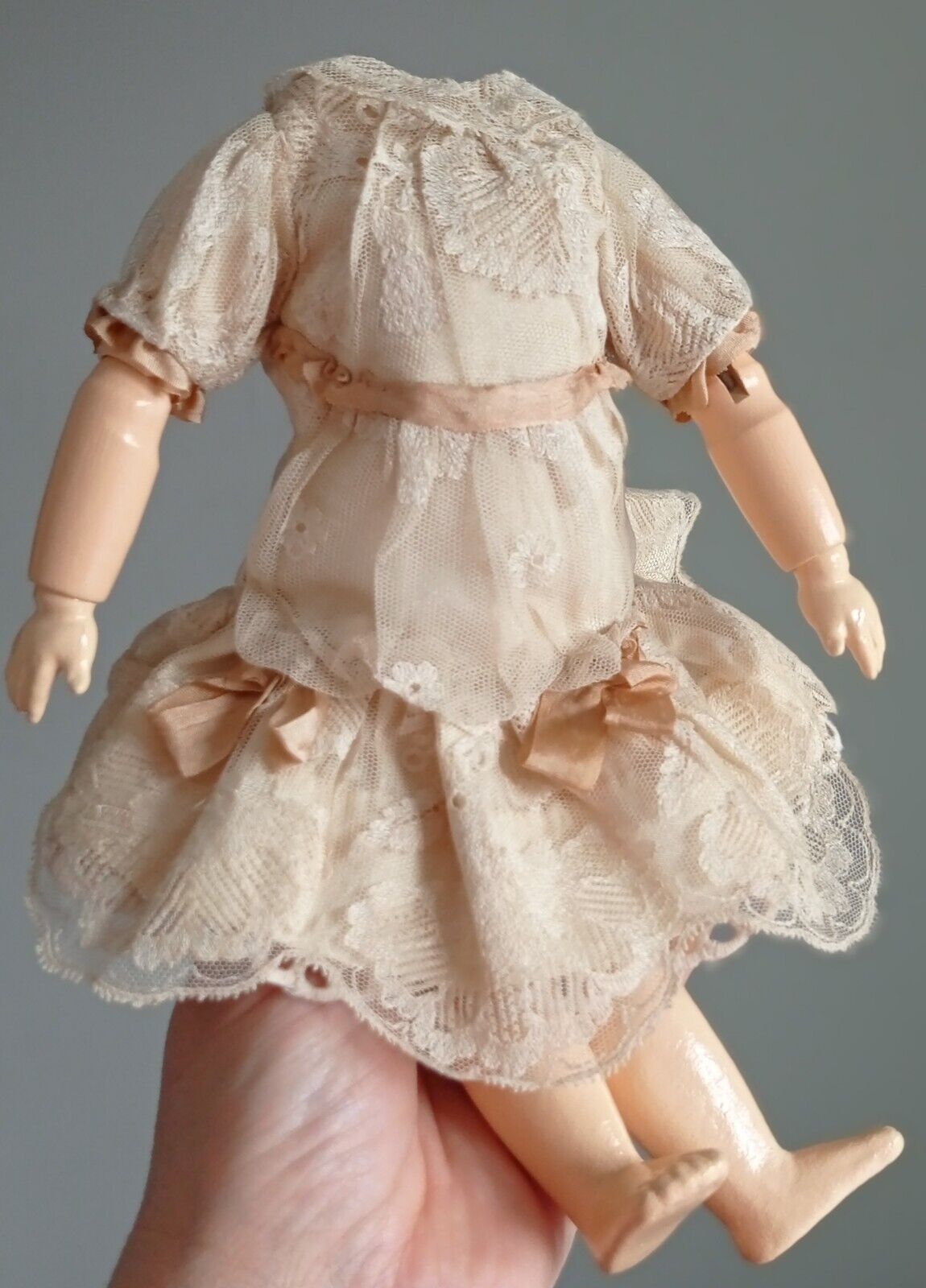 Vintage/antique doll body, wooden, dressed in a lacy dress