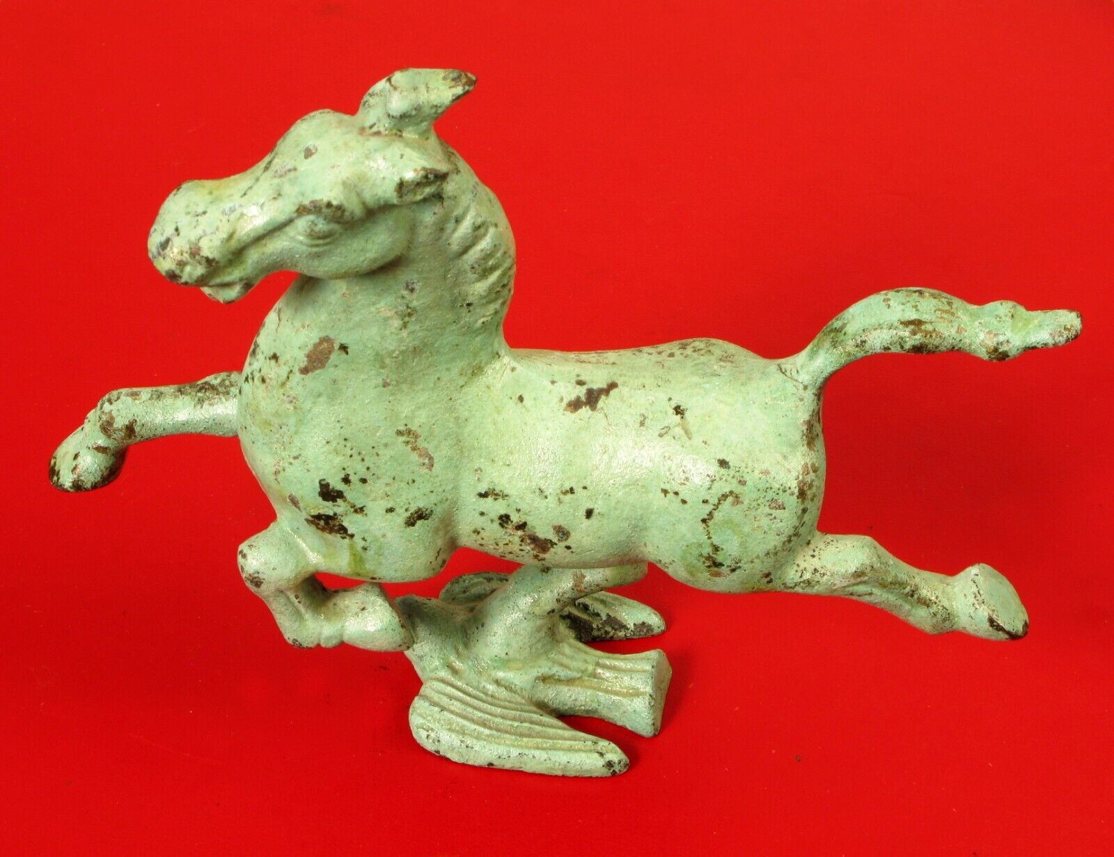 ANTIQUE CAST IRON FLYING HORSE ON THE BACK OF A BIRD AND KICKING UP HIS HEELS 