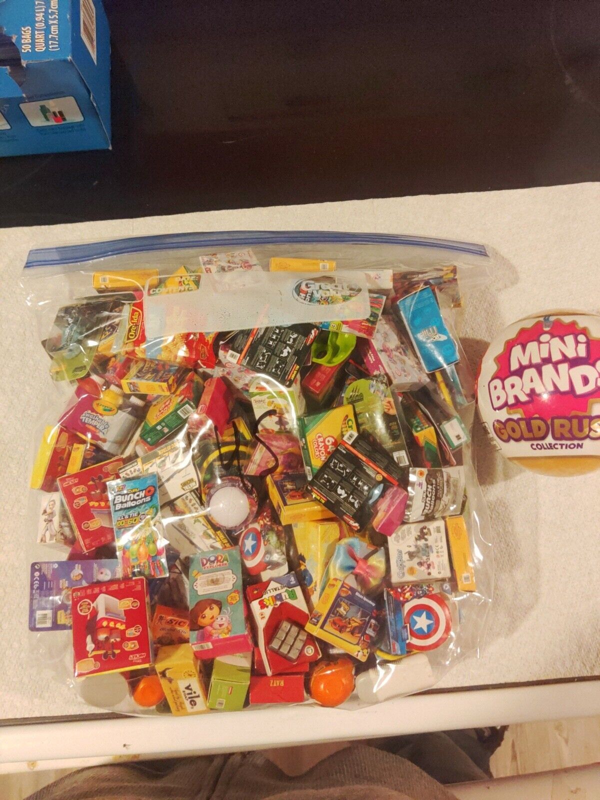 Lot Of Approx 135 Mini Brands And Unopened Mini Brands Gold Rush Ball