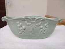 Vintage Rumrill pottery bowl with raised design cherubs and foliage. picture