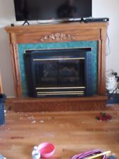Buck stove fireplace W gas logs with  wooden mantle. Vent less picture