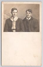 RPPC Two Young Men In Studio In Overcoats c1910 Postcard picture