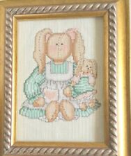 Cross stitch Little Girl  in a Pinafore  picture With Pony Tails Holding a Do picture