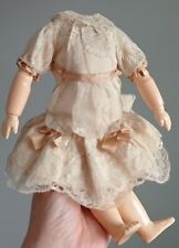 Vintage/antique doll body, wooden, dressed in a lacy dress picture