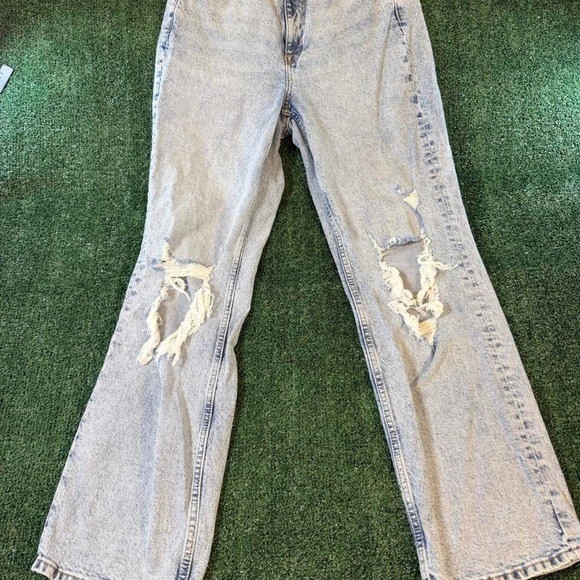 H&M Divided high-waisted distressed jeans in a light acid wash denim featuring