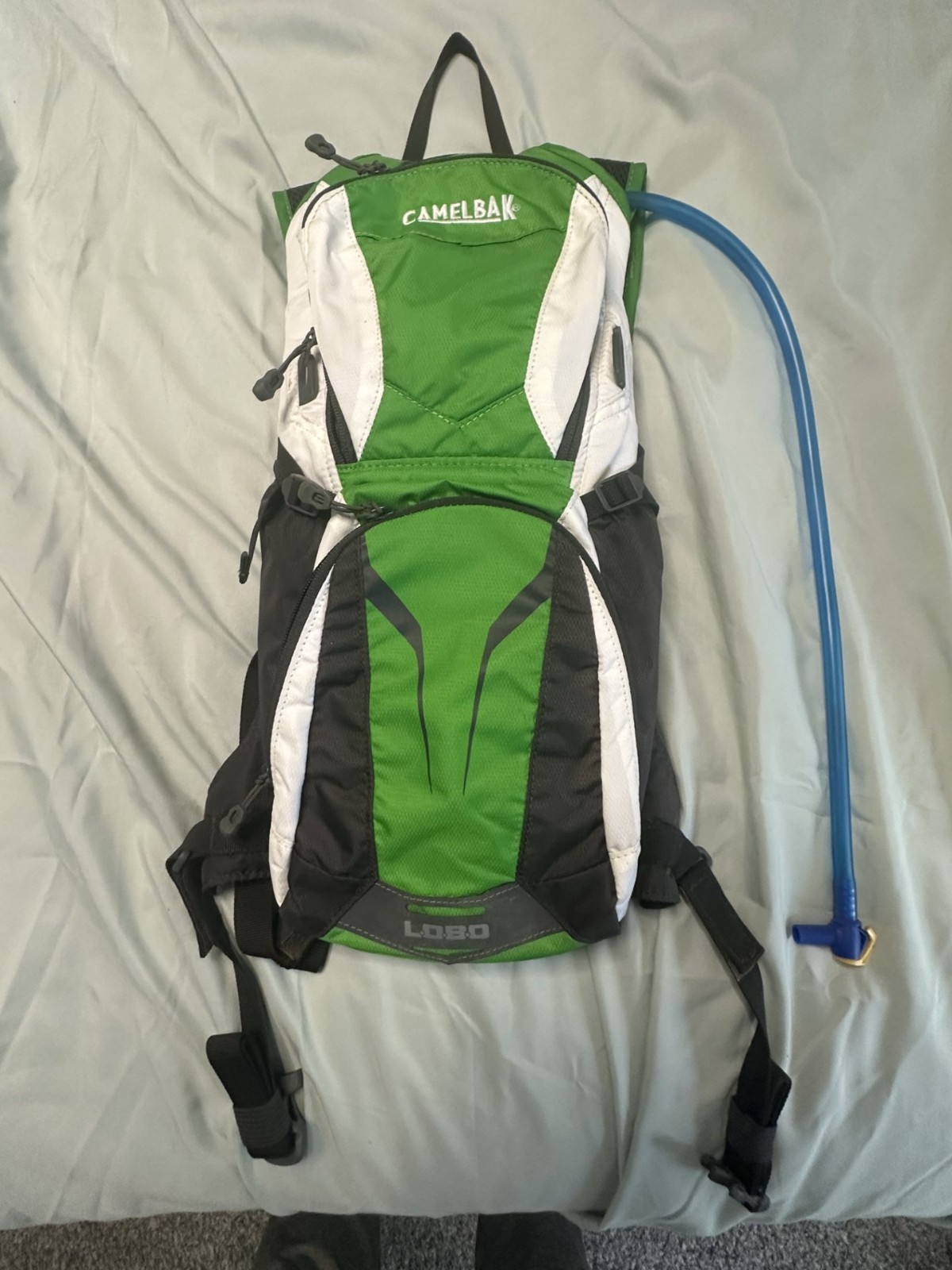 CamelBak Lobo hydration backpack in green, black and white.