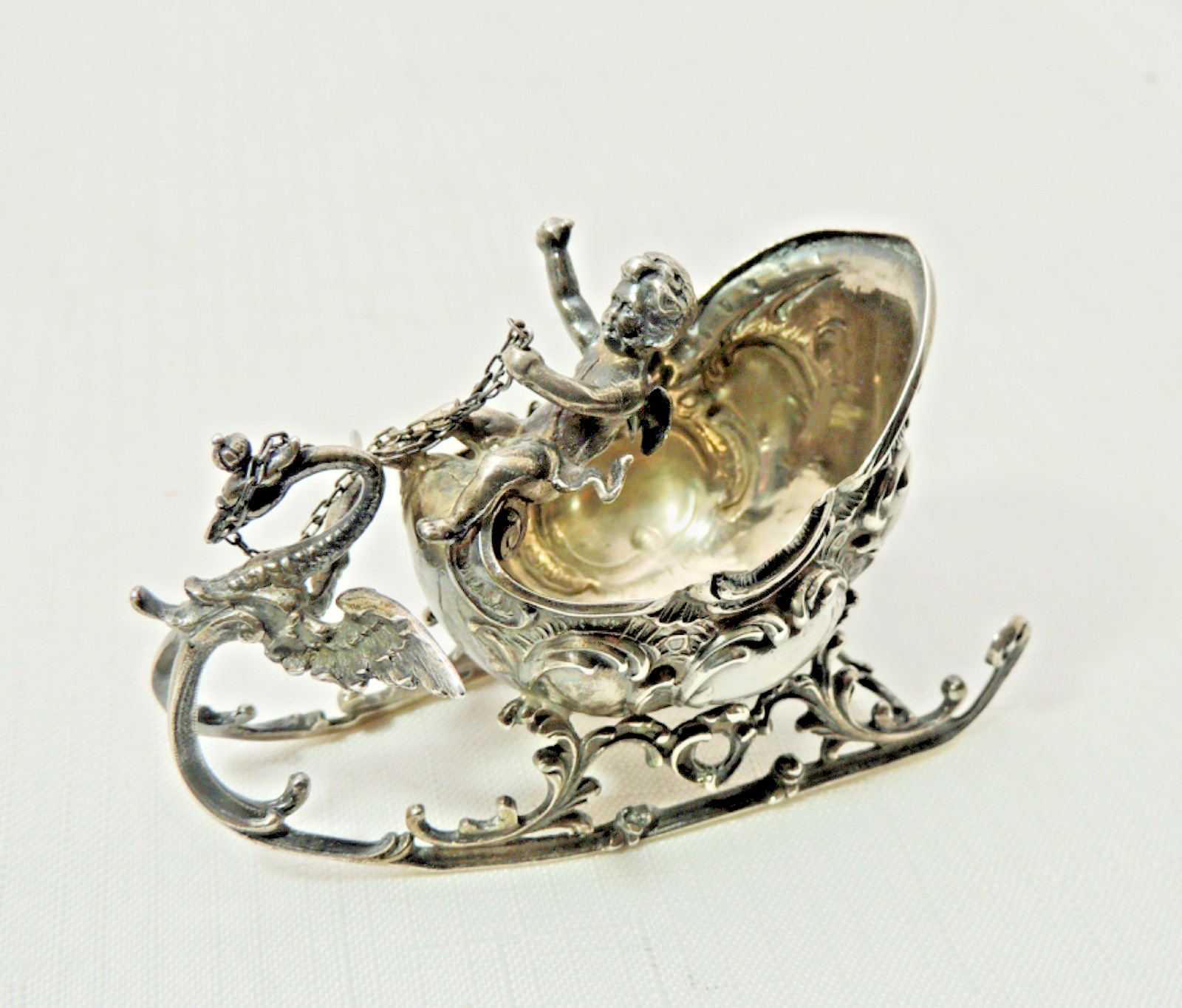 FIGURAL ROCOCCO STERLING SILVER SALT SLED WITH WINGED CHERUB AND DRAGON FIGURAL ROCOCCO STERLING SILVER SALT SLED WITH WINGED CHERUB AND DRAGON