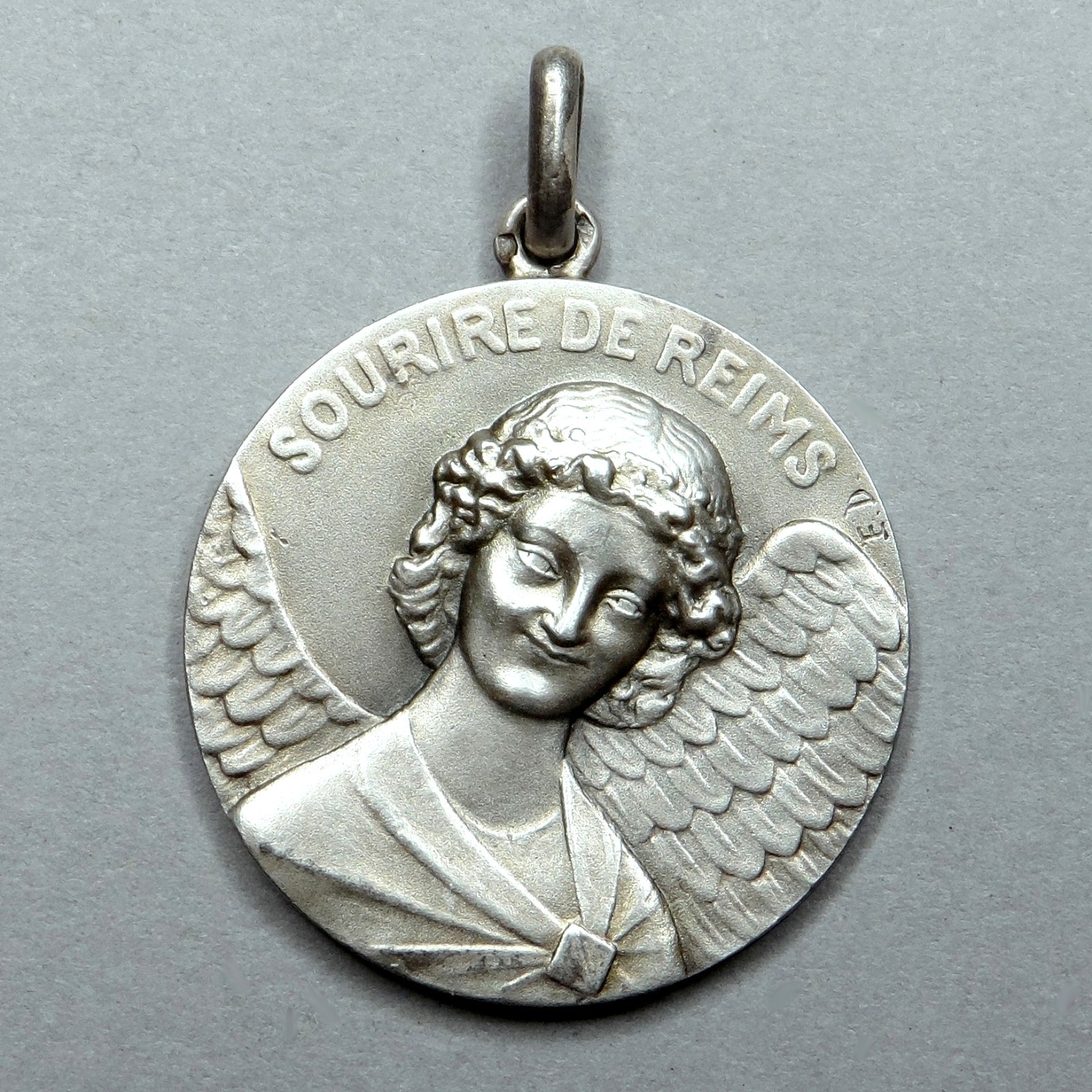 Smiling Angel, Cathedral of Reims. Antique Pendant. Silver Medal by Émile Dropsy Smiling Angel, Cathedral of Reims. Antique Pendant. Silver Medal by Émile Dropsy