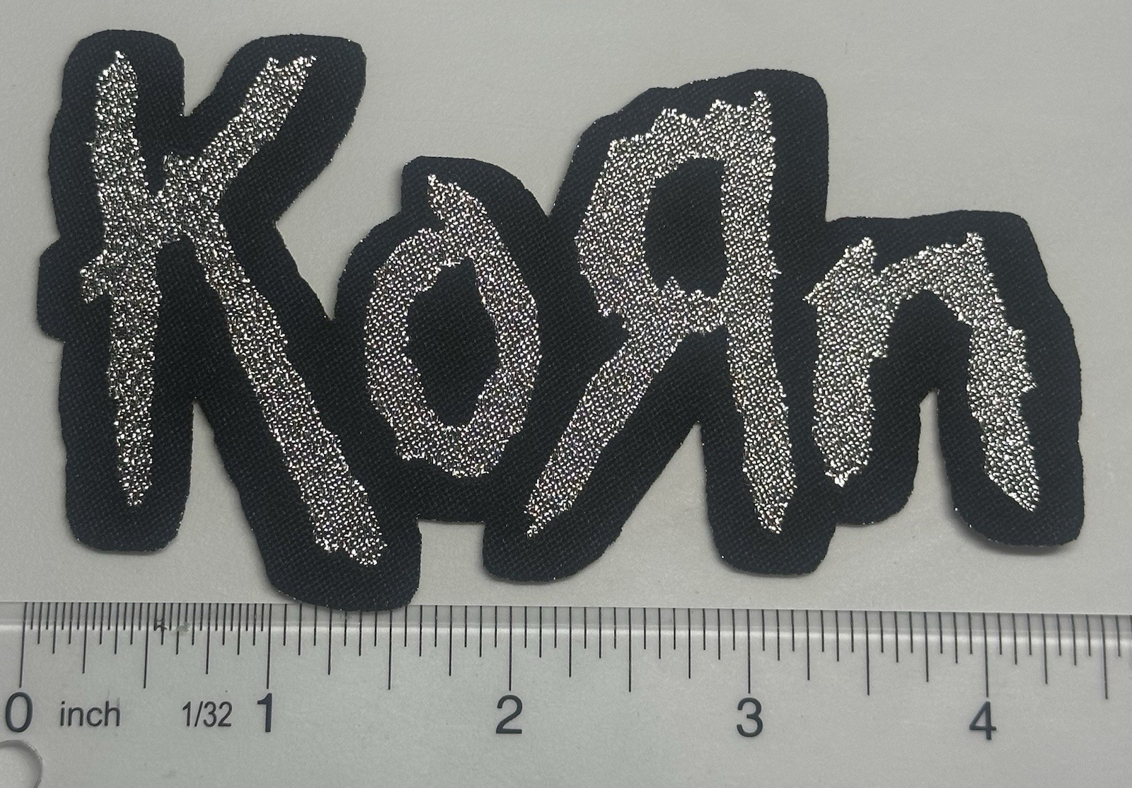 Korn Metallic Silver Logo Black Border Woven Patch Korn Metallic Silver Logo Black Border Woven Patch