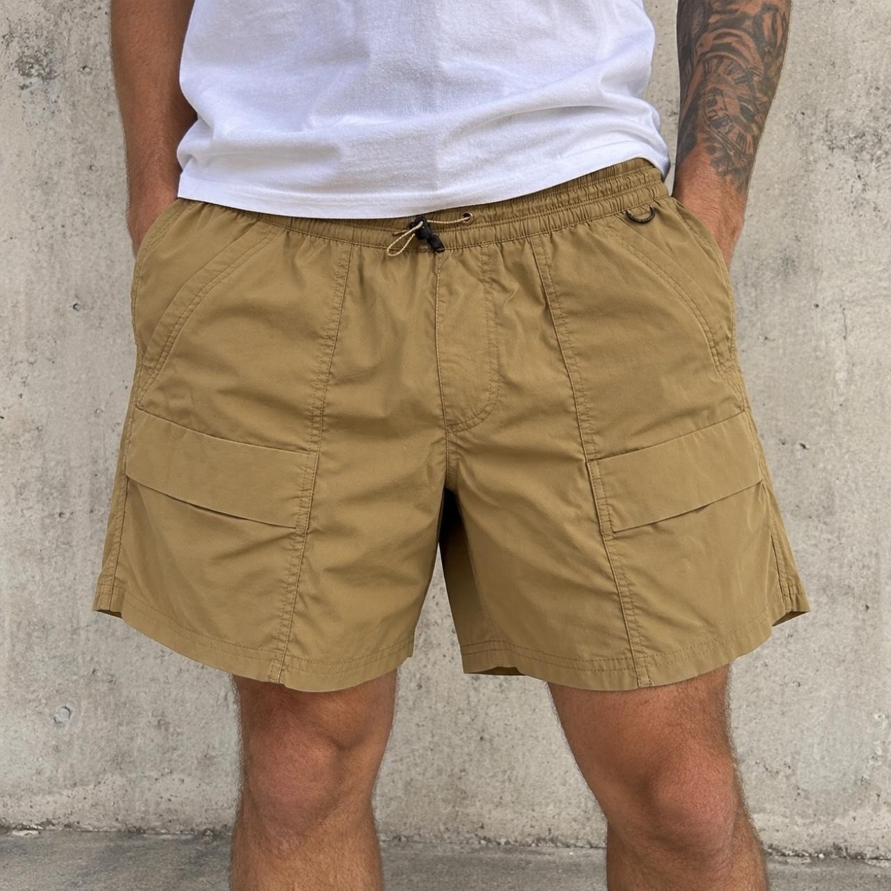 REI Co-op men\'s lightweight cargo/hiking shorts in tan/khaki. Relaxed outdoor