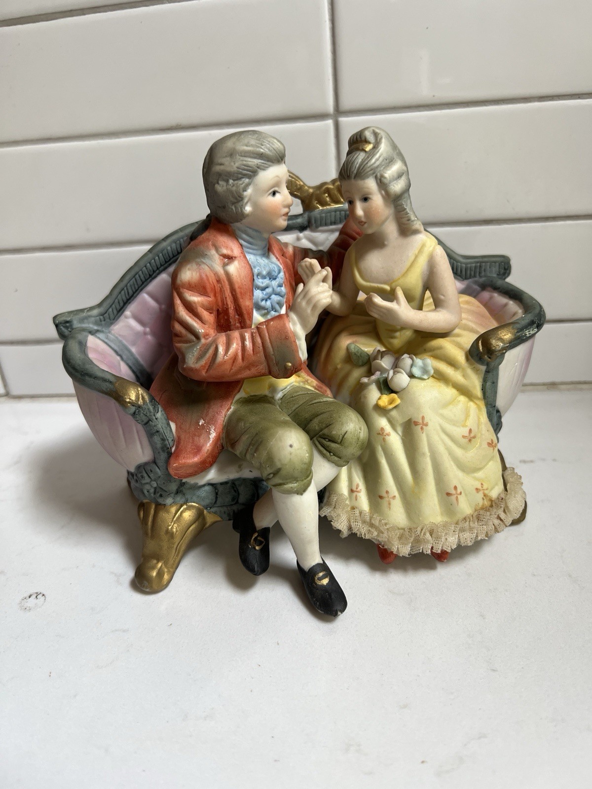 VINTAGE CUCCI ROYAL CROWN, COURTING VICTORIAN COUPLE SEATED ON COUCH VINTAGE CUCCI ROYAL CROWN, COURTING VICTORIAN COUPLE SEATED ON COUCH