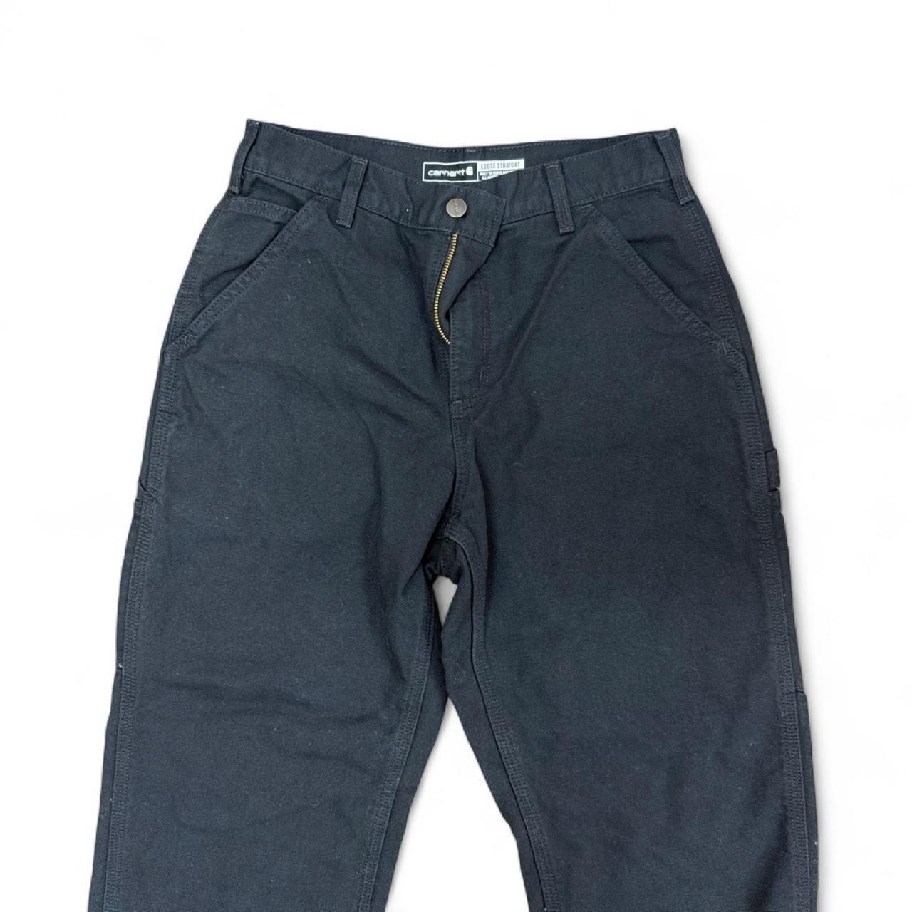 Black Carhartt loose straight-fit canvas work pants designed for durability Black Carhartt loose straight-fit canvas work pants designed for durability