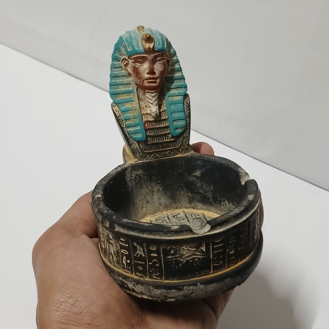 Vintage Egyptian-themed ashtray featuring a pharaoh head intricate hieroglyphic Vintage Egyptian-themed ashtray featuring a pharaoh head intricate hieroglyphic