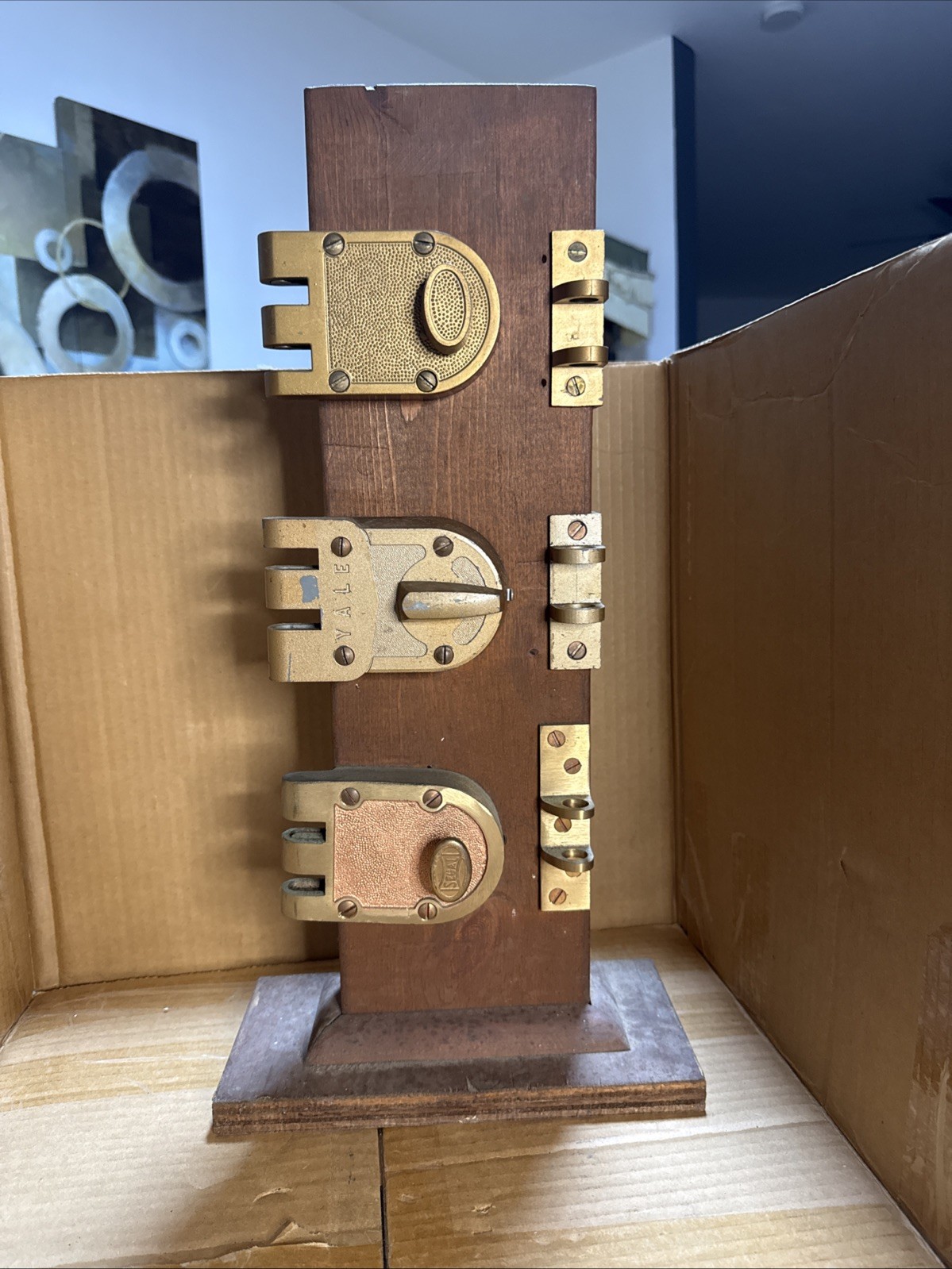 Vintage retail display stand holding three brass jimmy-proof rim deadbolt locks Vintage retail display stand holding three brass jimmy-proof rim deadbolt locks