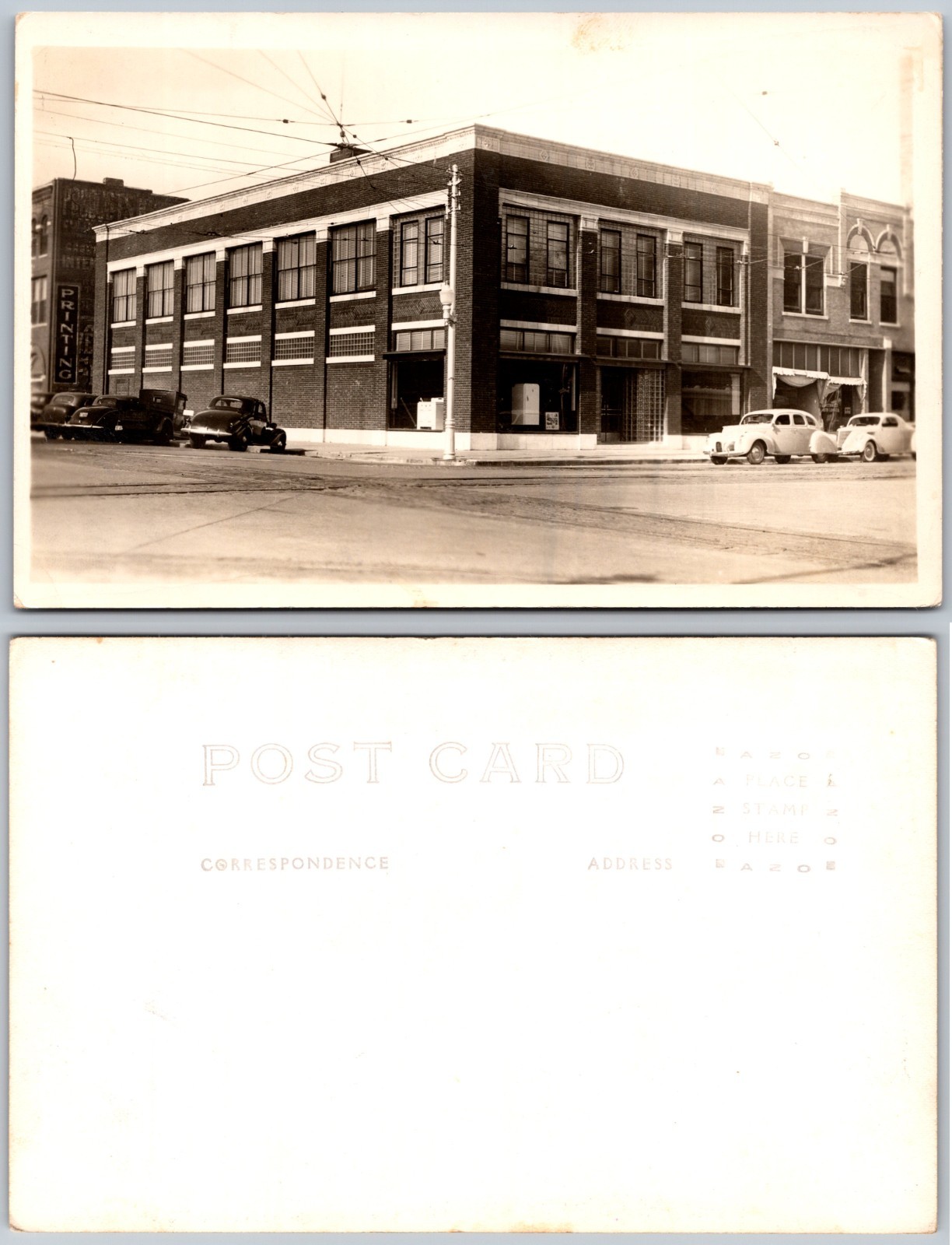 RPPC Brick Commercial Building Cars Street Corner Wires Photo Postcard