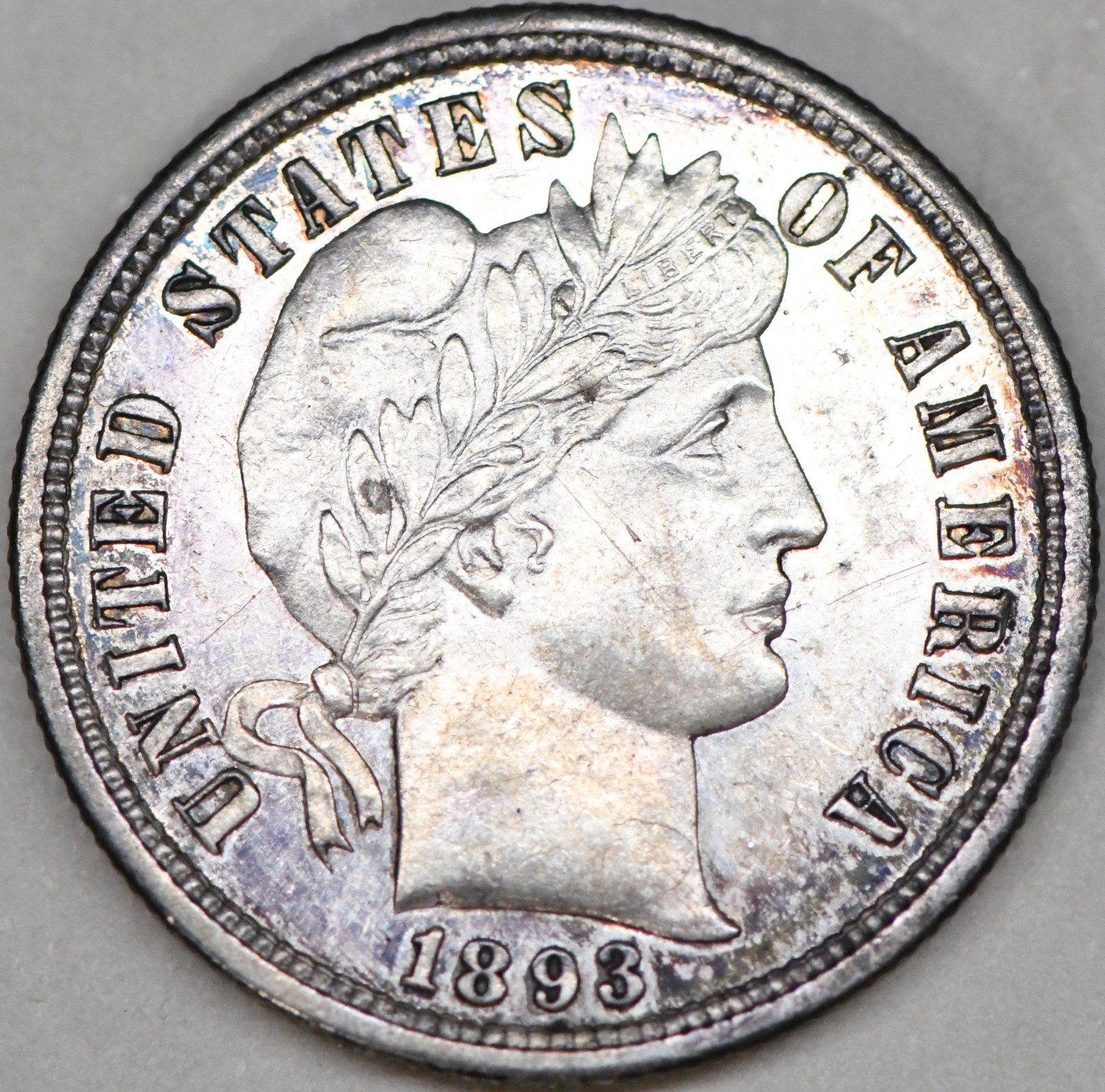 1893 s barber dime with beautiful toning and a repunched mint mark in Au/Bu