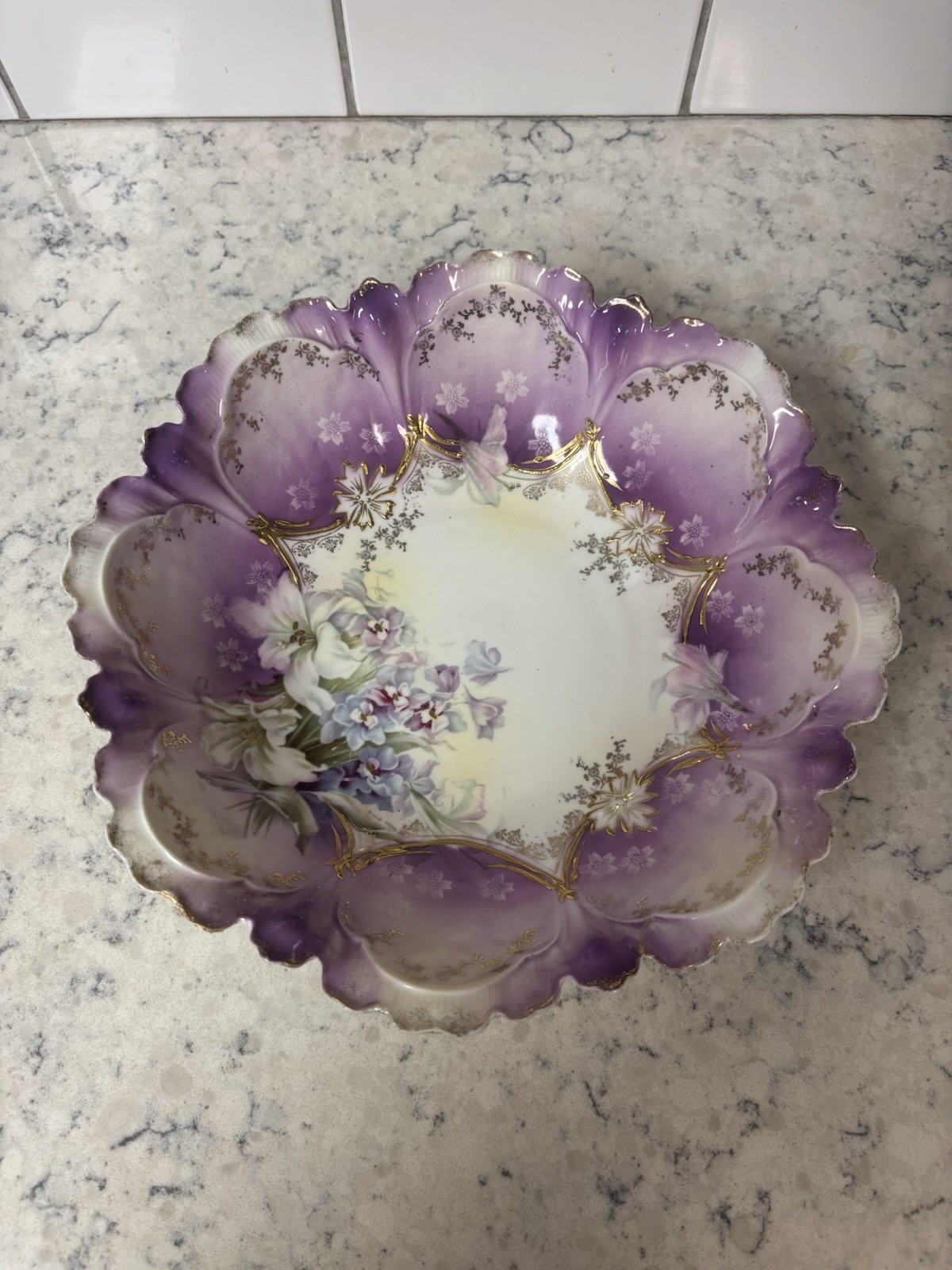 Antique Limoges hand-painted porcelain bowl with purple and floral motifs. Antique Limoges hand-painted porcelain bowl with purple and floral motifs.