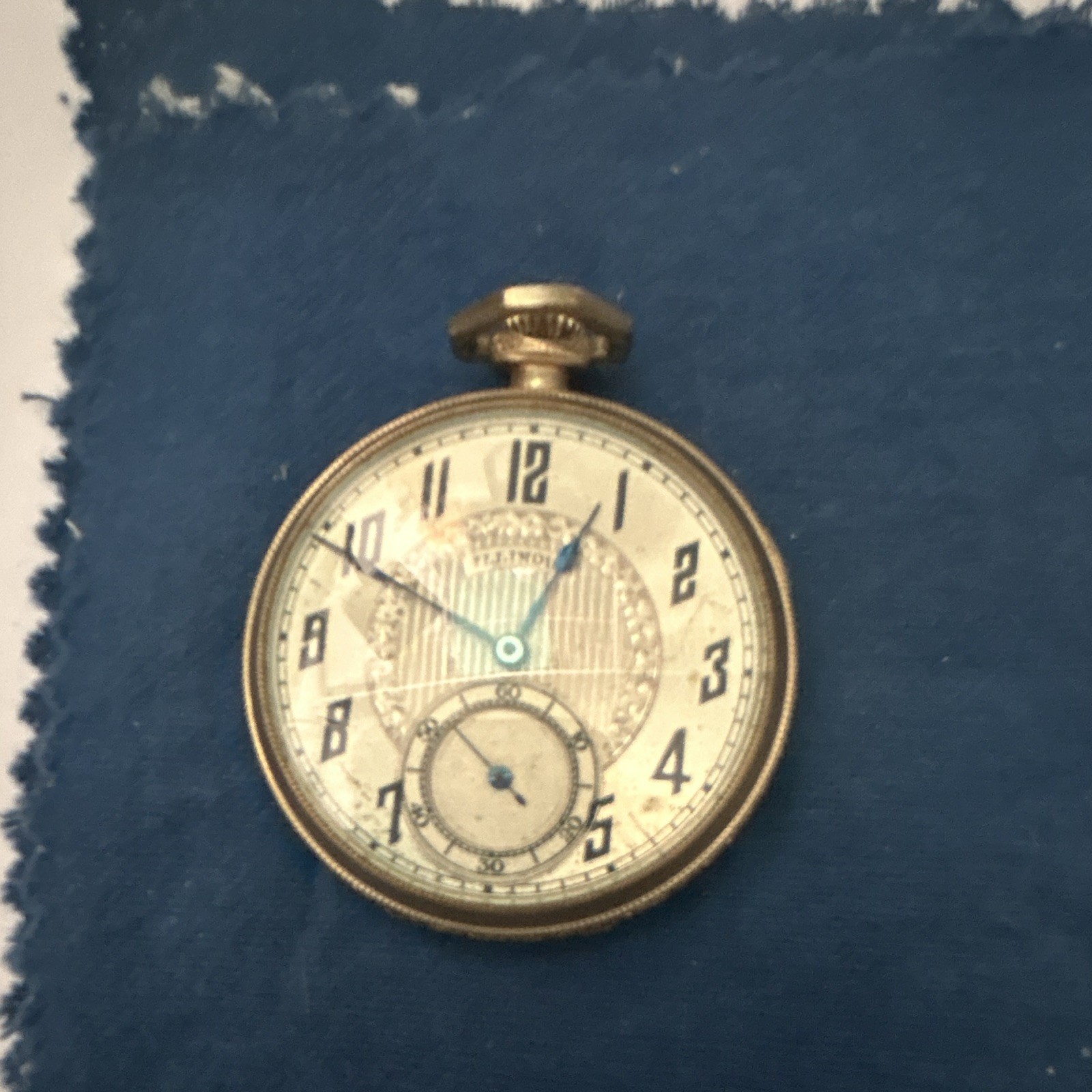 The image shows an antique open-face pocket watch, likely an Illinois Watch Co. The image shows an antique open-face pocket watch, likely an Illinois Watch Co.