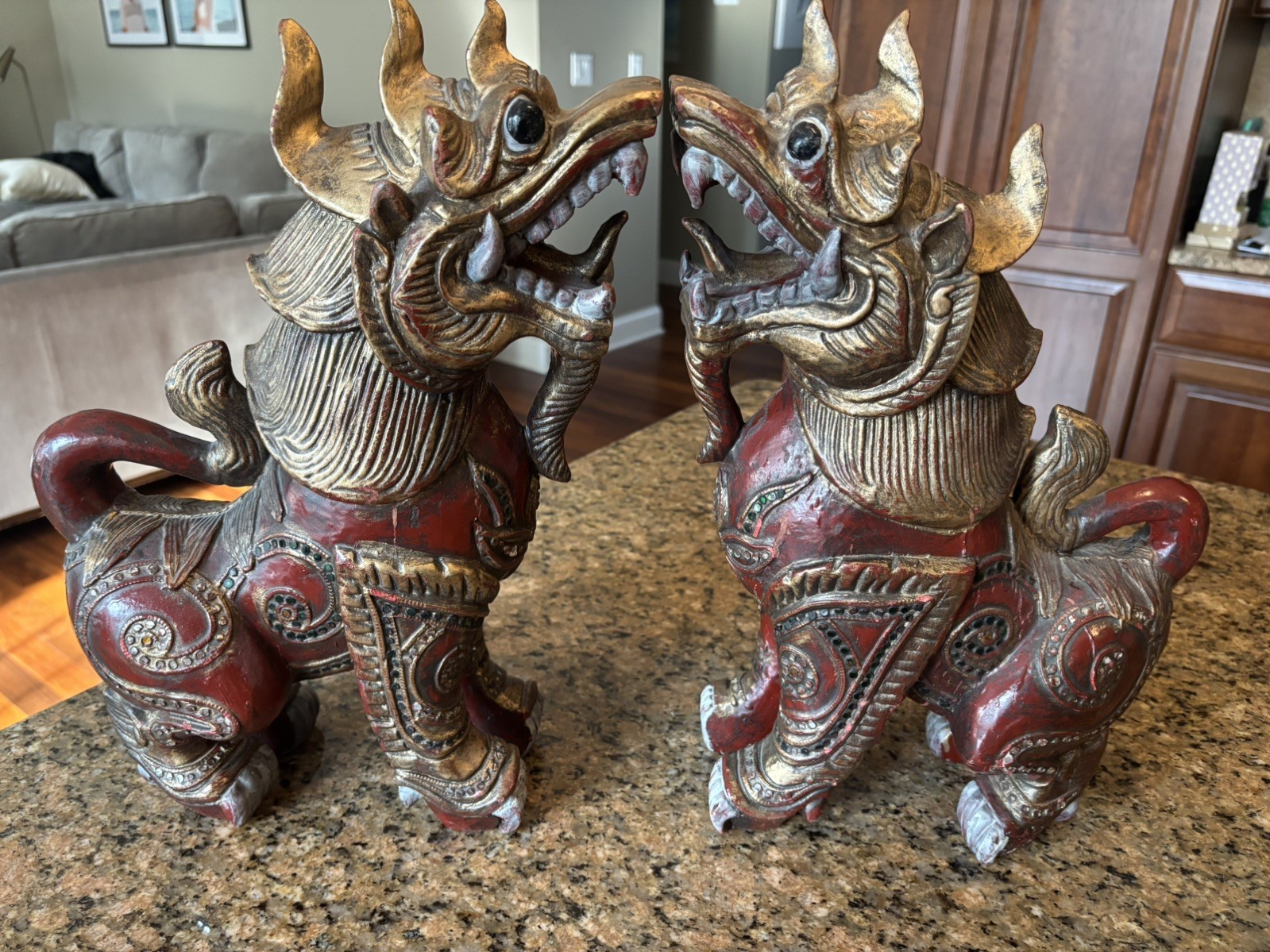 A pair of Vintage hand carved glass-inlaid Wooden Chinthe statues in Red / Gold A pair of Vintage hand carved glass-inlaid Wooden Chinthe statues in Red / Gold