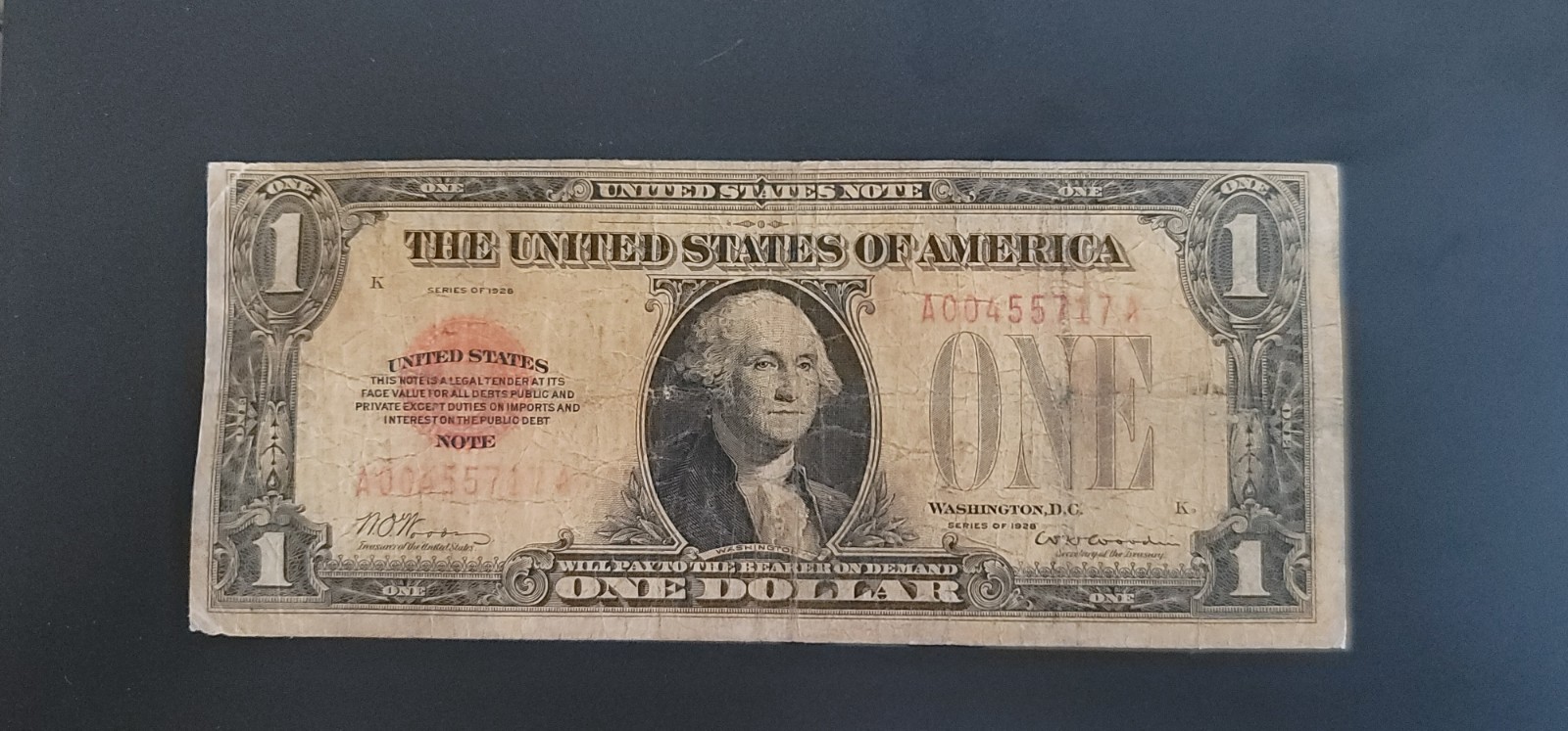 1928 $1 Red Seal United States Note Funnyback – Heavily Circulated – Ungraded 1928 $1 Red Seal United States Note Funnyback – Heavily Circulated – Ungraded