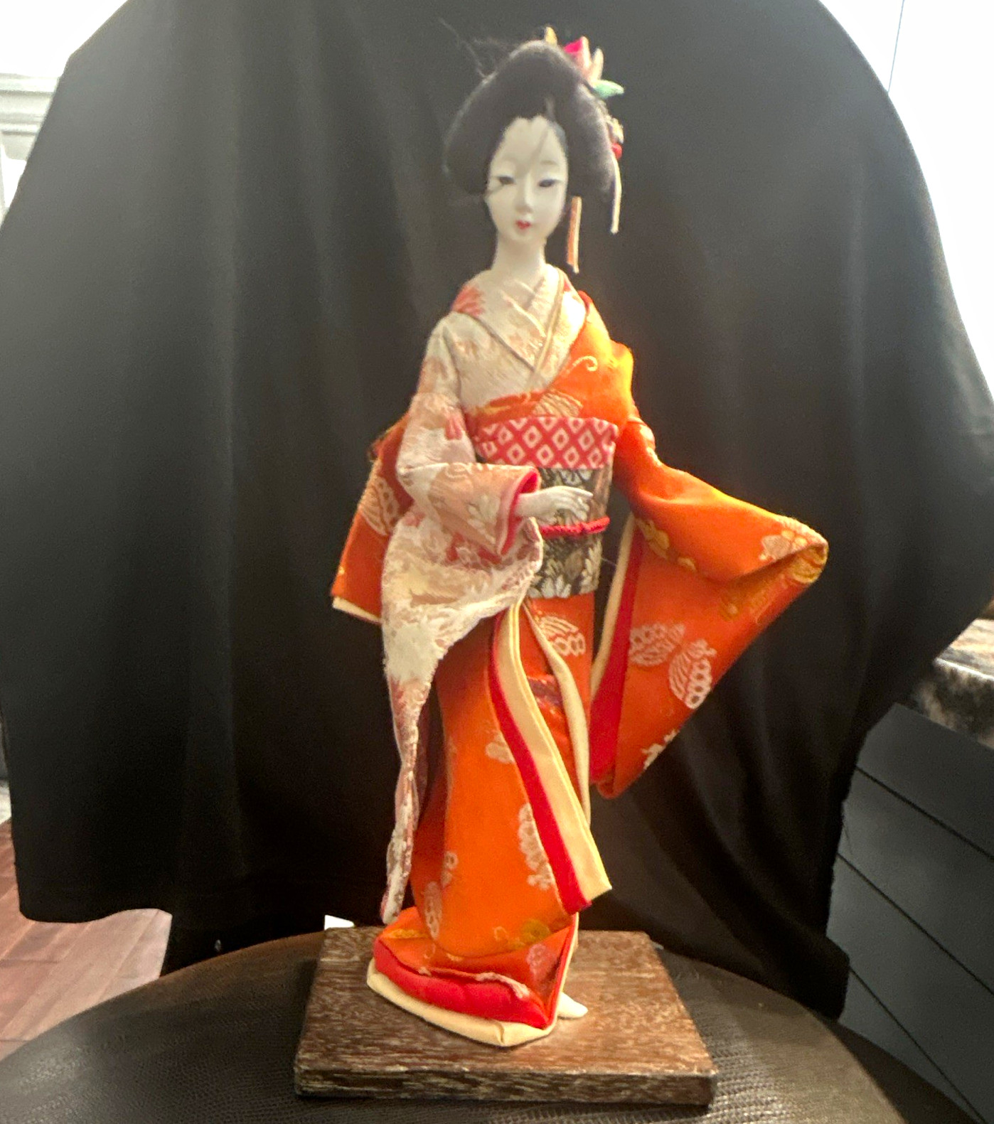 Vintage Japanese Geisha Doll Orange Kimono on Wooden Stand. Vintage Japanese Geisha Doll Orange Kimono on Wooden Stand.