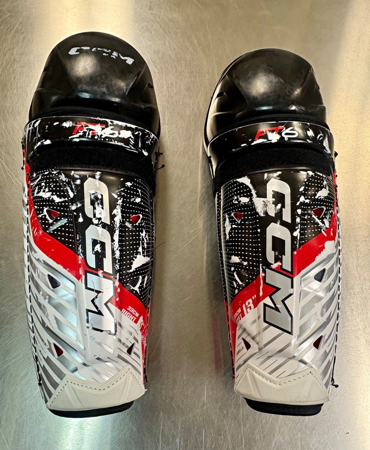CCM JetSpeed Shin Guards 33cm 13in Adjustable Black Red White Pair CCM JetSpeed Shin Guards 33cm 13in Adjustable Black Red White Pair