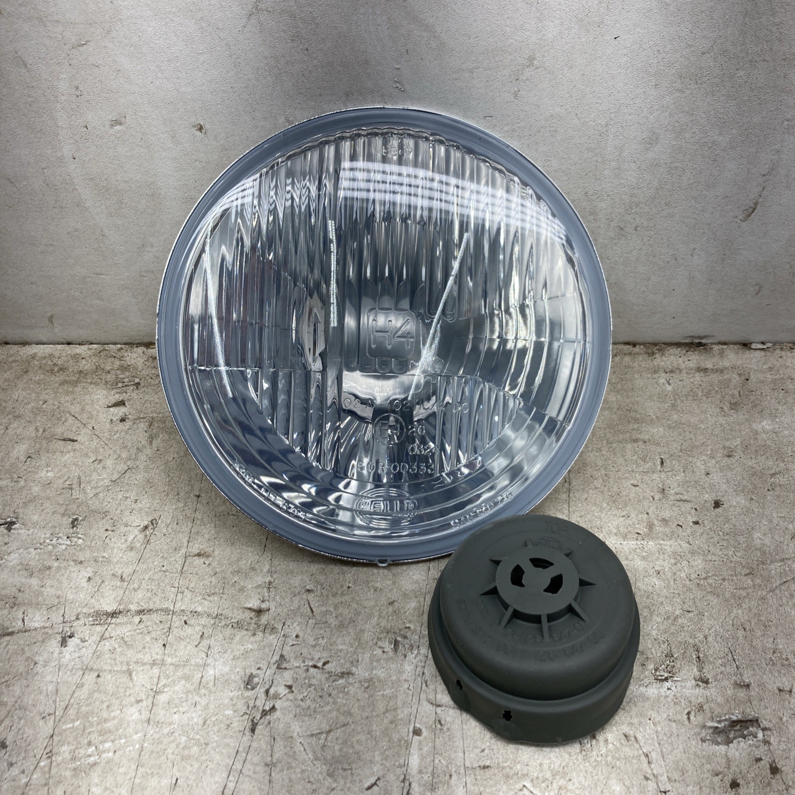 Hella 7” Round Headlight Assembly 1A6 002. 395-031 (New Old Stock)