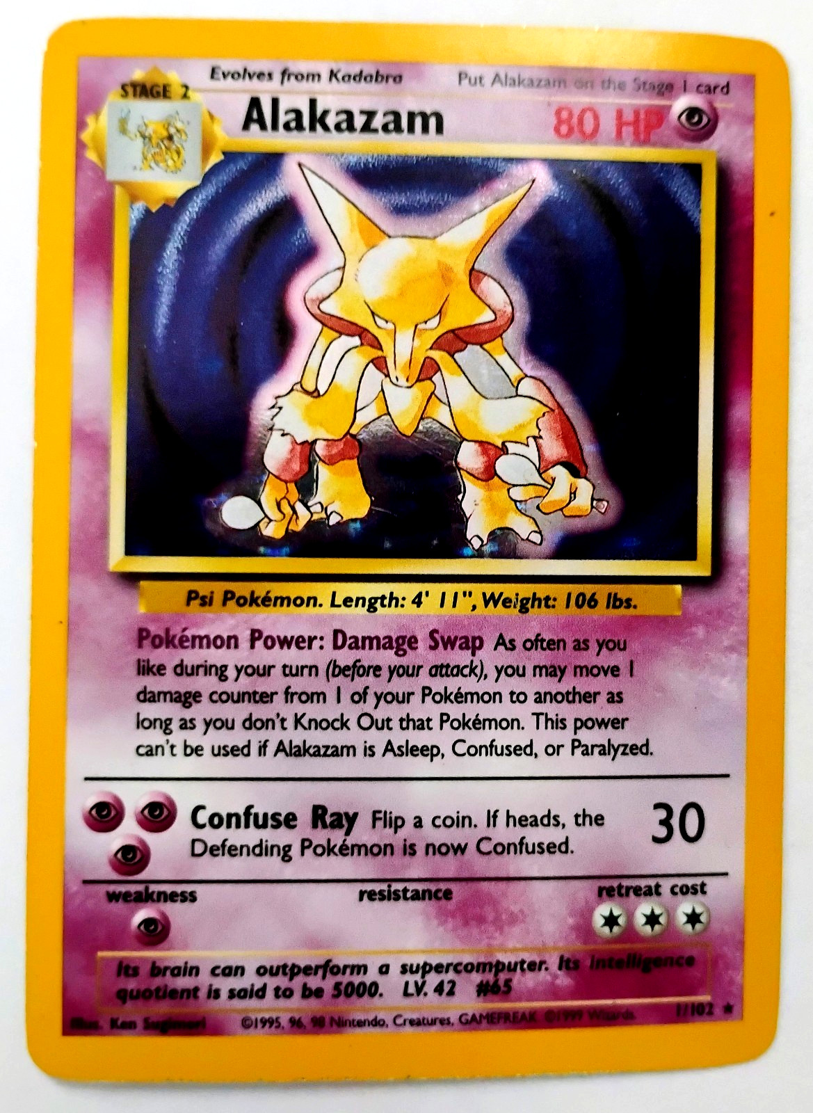 1999 POKEMON HOLOFOIL ALAKAZAM 1/102 #65BASE SET WOTC TCG HOLOGRAM CARD NM/MINT 1999 POKEMON HOLOFOIL ALAKAZAM 1/102 #65BASE SET WOTC TCG HOLOGRAM CARD NM/MINT