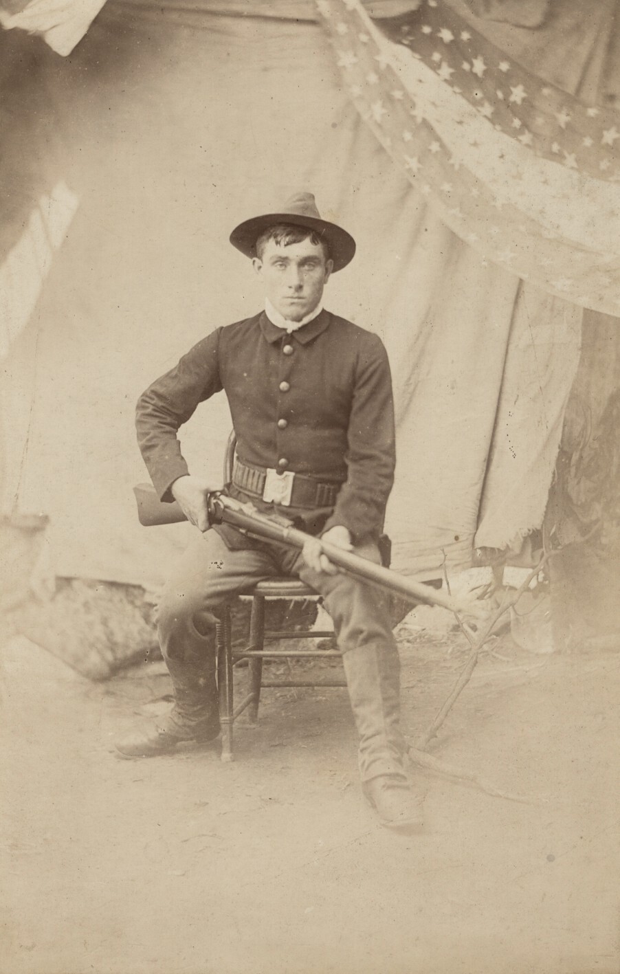 c. 1870's American Soldier Seated with Rifle, Star Banner in Back Photograph