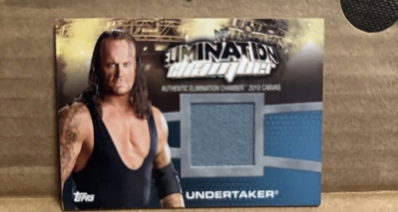 2010 Topps WWE - Elimination Chamber Mat Relics Undertaker #EC-15 (MEM)