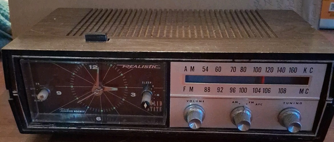 Vintage Realistic Solid State AM/FM clock radio with an analog clock face. Vintage Realistic Solid State AM/FM clock radio with an analog clock face.