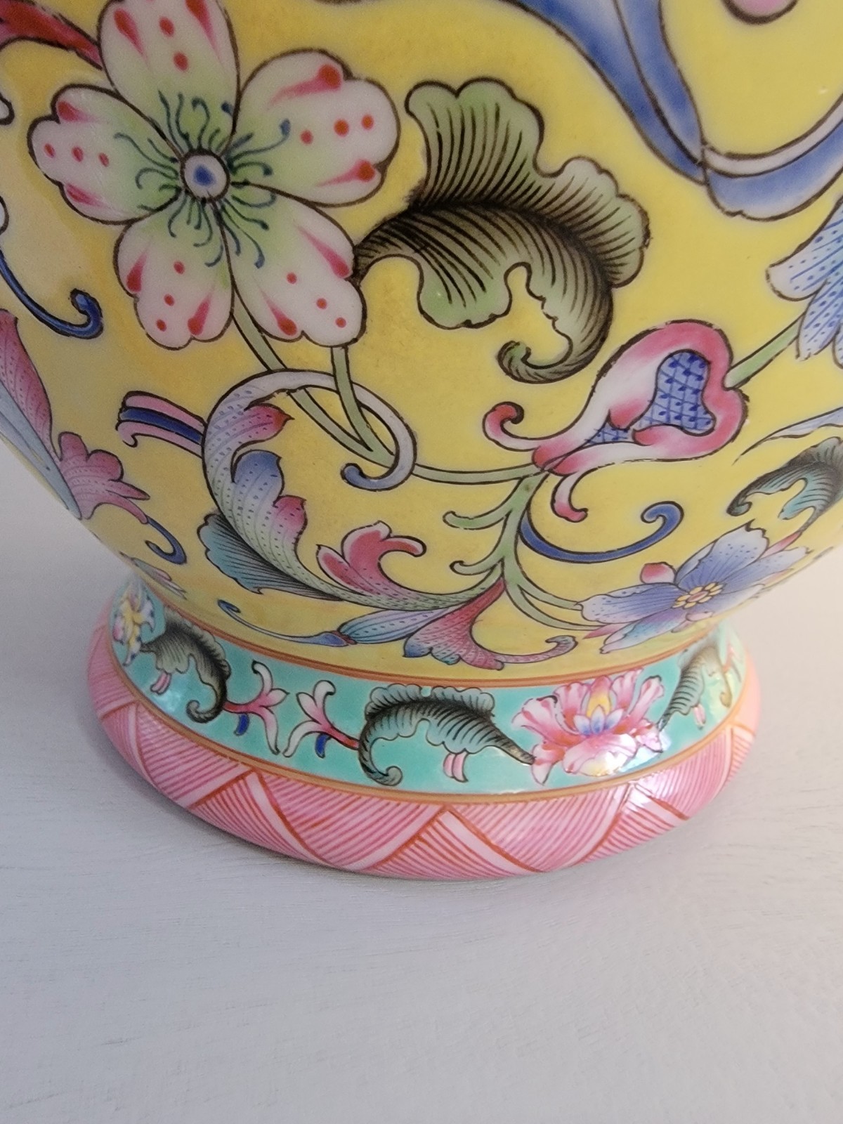This is a Chinese Famille Rose (or Fencai) porcelain vase 