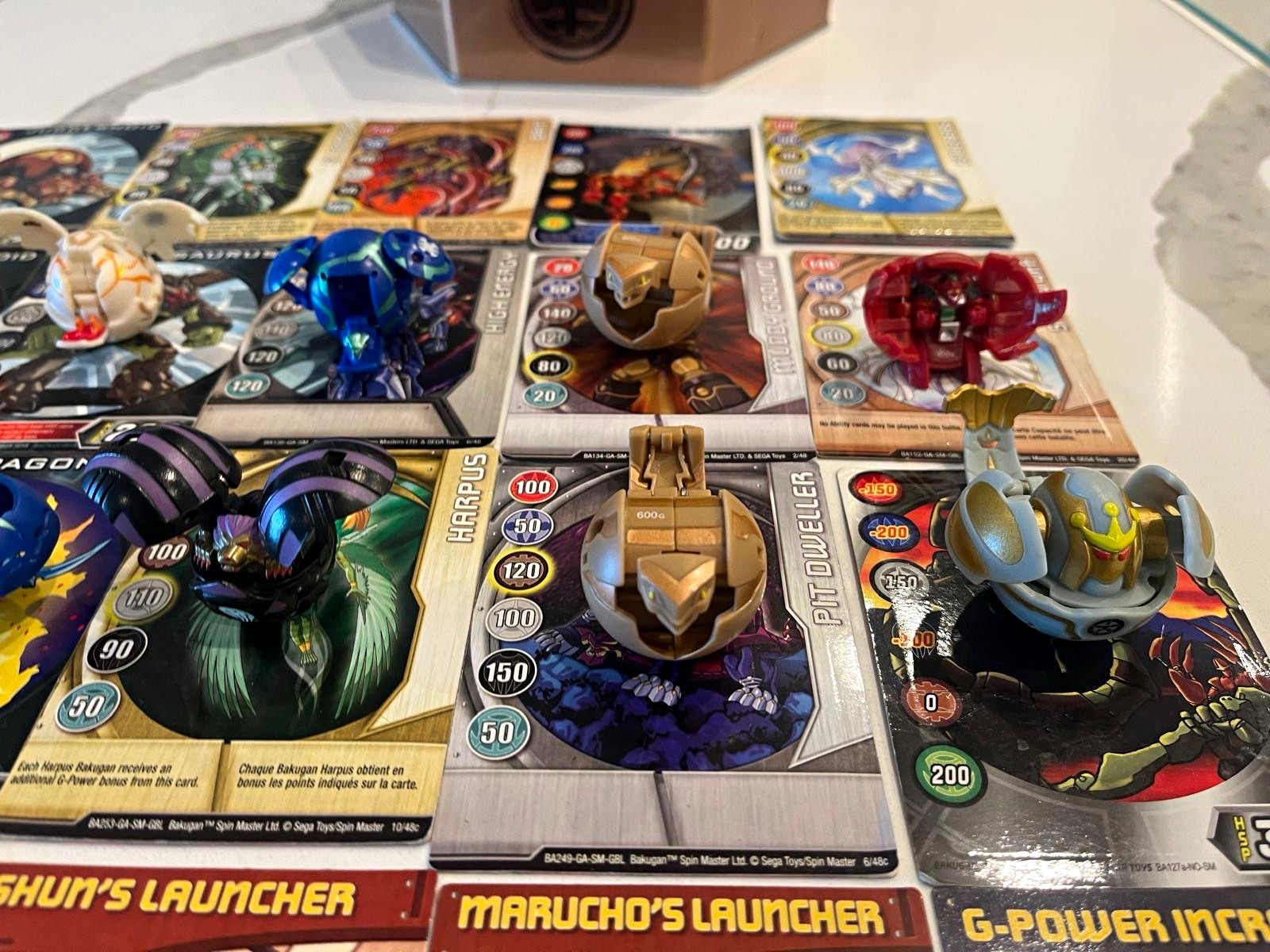 Vintage Bakugan Battle Brawlers Lot – 12 Figures, ~50 Cards, Collector\'s Tin.