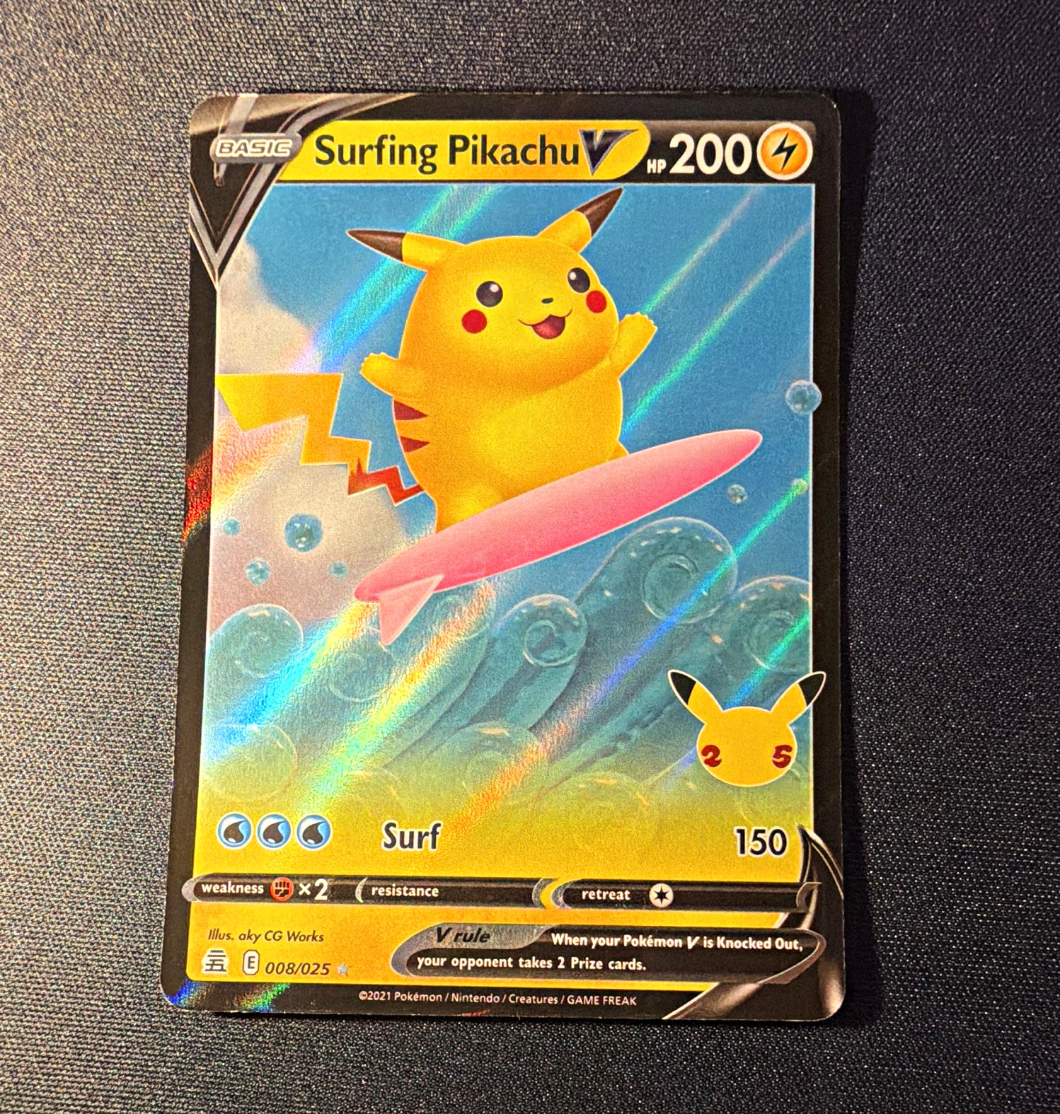The Pokémon Company Surfing Pikachu V 008/025 Celebrations Holo Ultra Rare EN The Pokémon Company Surfing Pikachu V 008/025 Celebrations Holo Ultra Rare EN