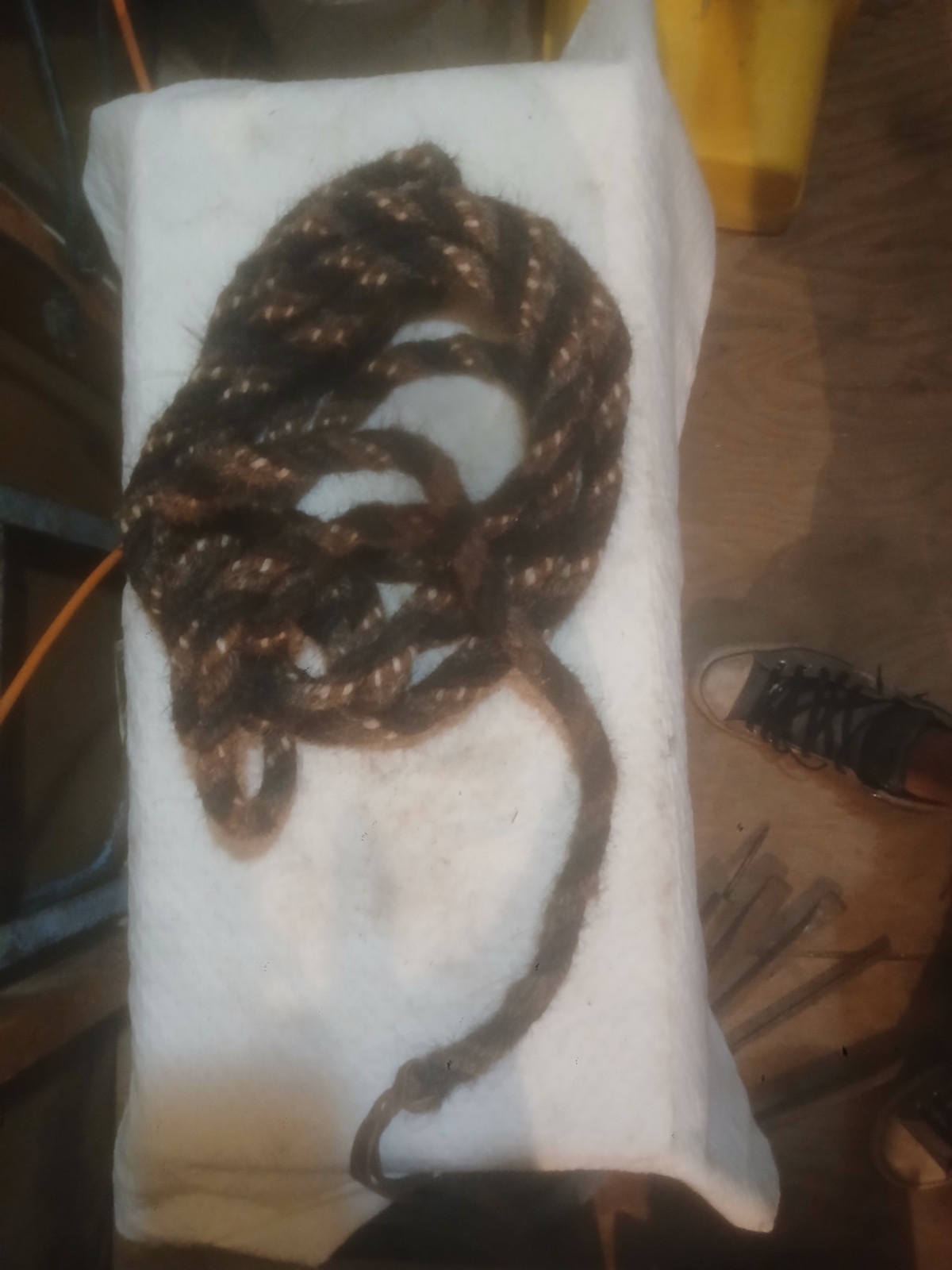 The item shown is a traditional hand-twisted or braided horsehair mecate rein