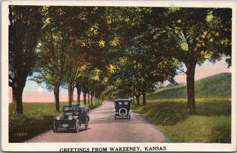 WAKEENEY, Kansas Greetings Postcard Automobiles / Road Scene c1920s Unused