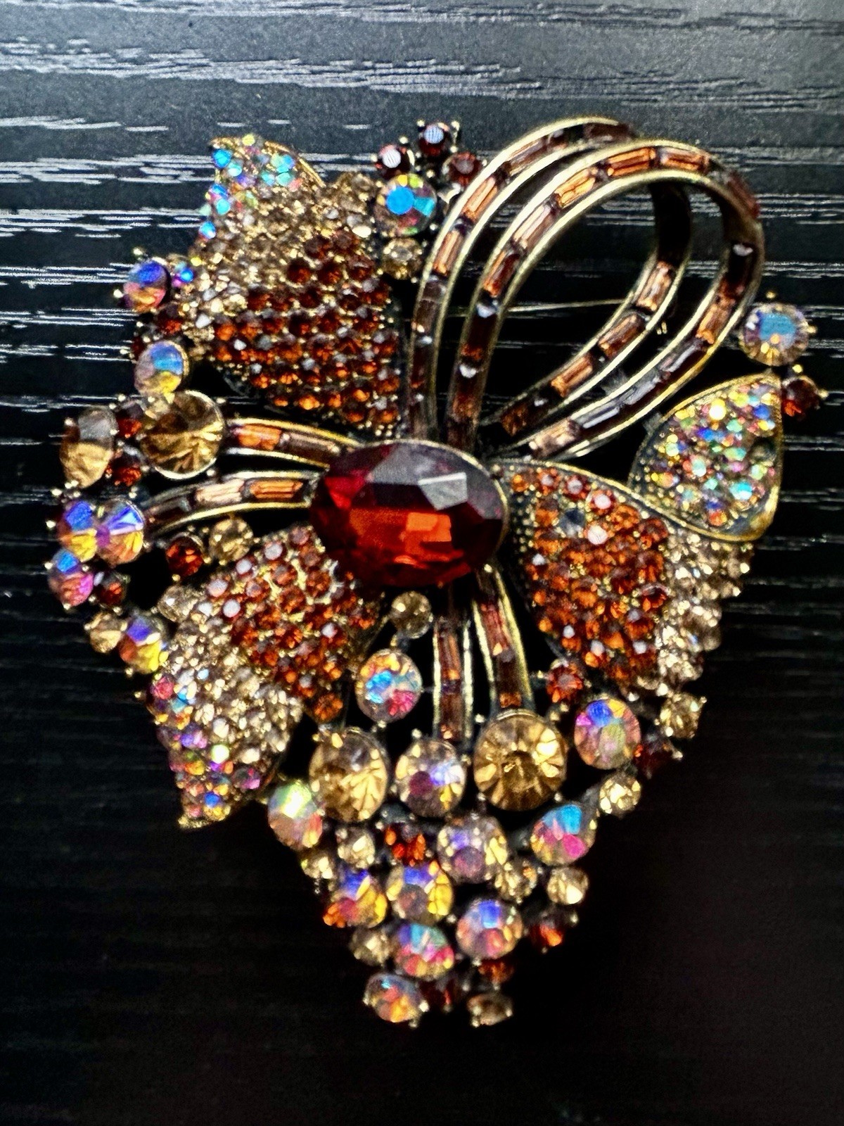 Large Multi Colored Gold Tone Bow Brooch with Center Ruby Stone Look. Large Multi Colored Gold Tone Bow Brooch with Center Ruby Stone Look.