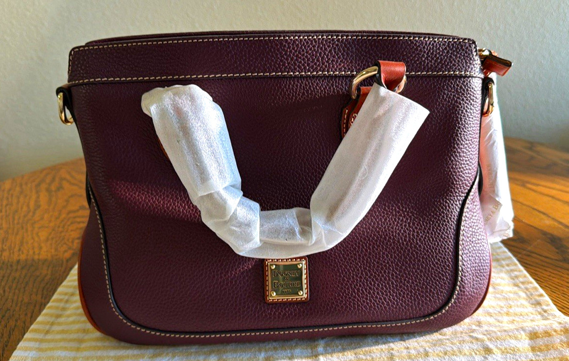 Dooney & Bourke 100% Leather, leather tassels, leather long Strap. Reg Card. Dooney & Bourke 100% Leather, leather tassels, leather long Strap. Reg Card.