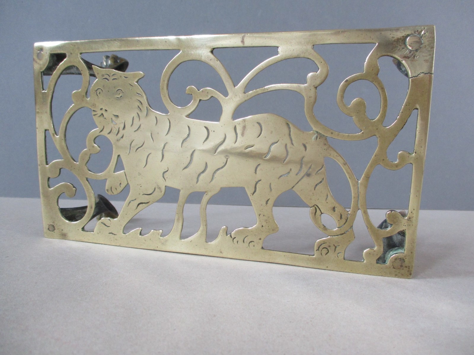 An Antique Brass Metal Trivet Stand with Tiger C. Victorian Era Hearth Range