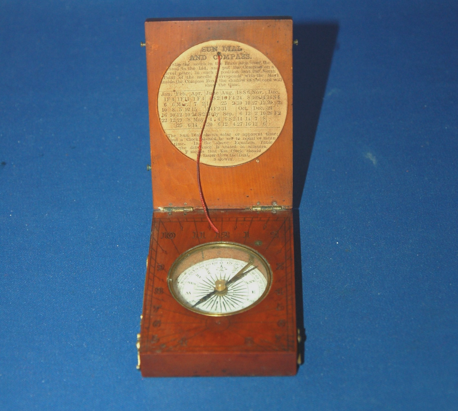 A rare antique 19th century directional compass and sundial in wooden case.