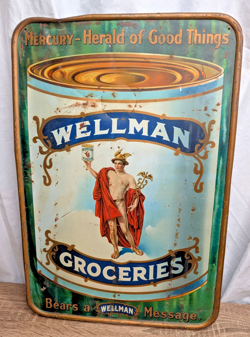 Rare Antique Wellman Groceries Metal Tin Sign Mercury Herald Good Things 18.75”
