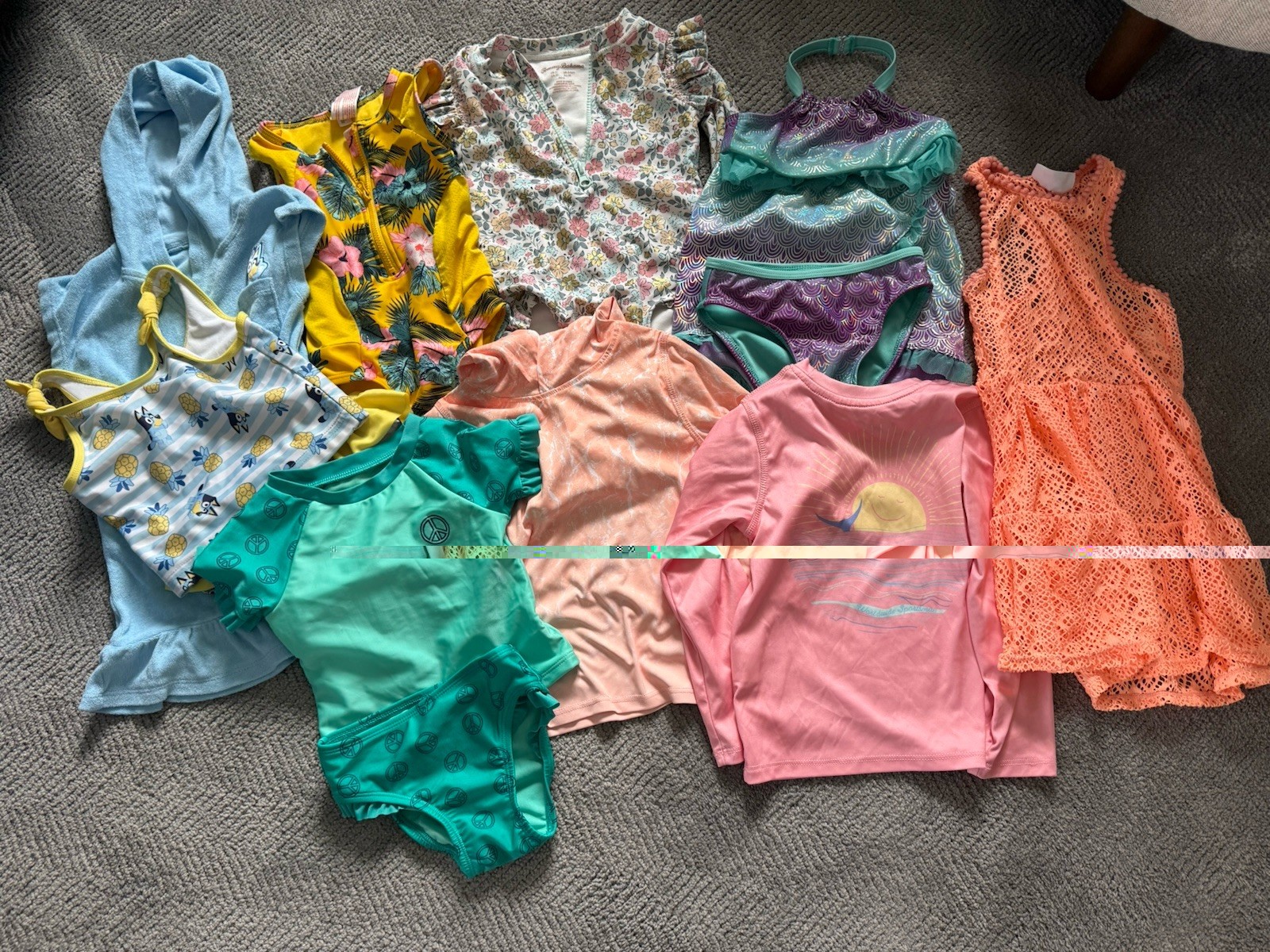 Assortment of 5 swimsuits 18 month-3t, two swim shirts, and two cover ups Assortment of 5 swimsuits 18 month-3t, two swim shirts, and two cover ups