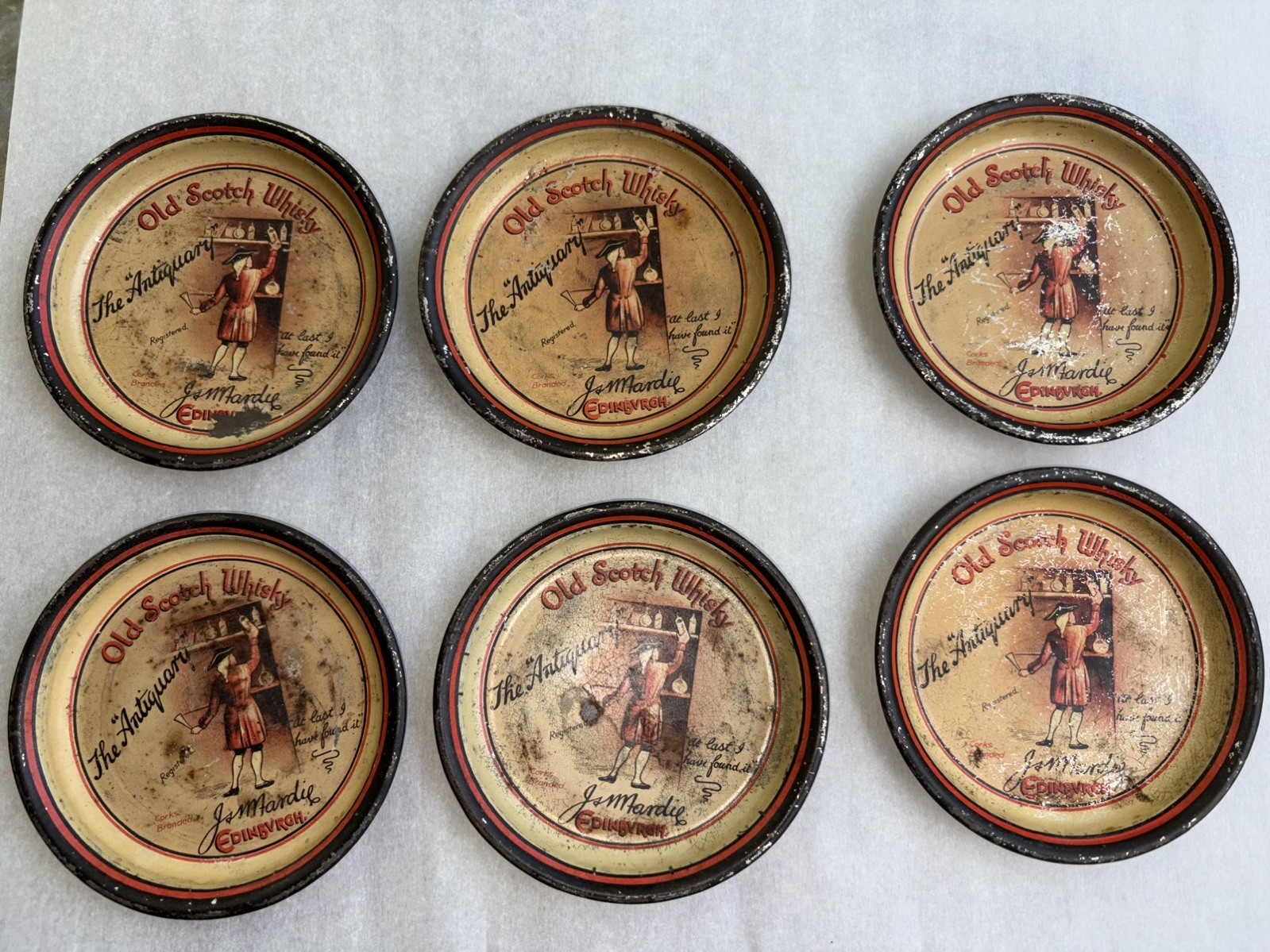 6 VERY RARE  PRE PROHIBITION TIP TRAYS “ OLD SCOTCH WHISKY THE ANTIQUARY” app 4”