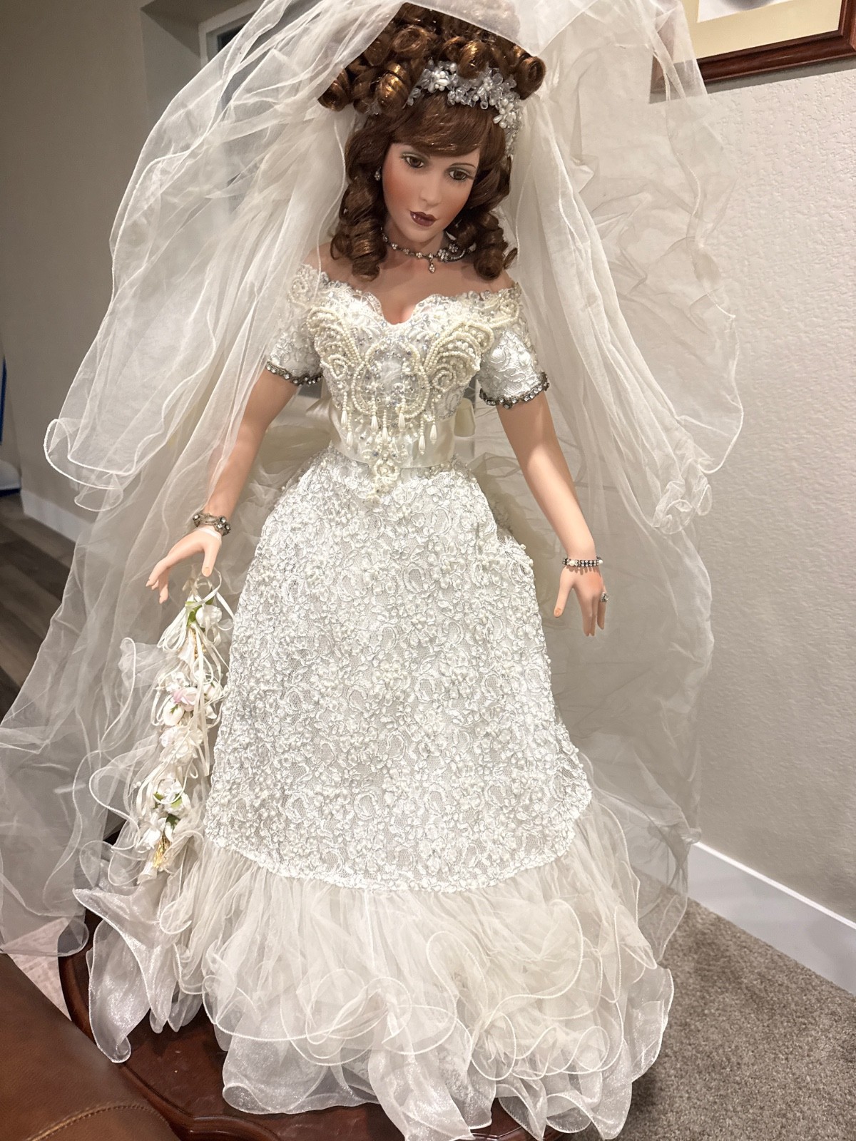 This is a large high-end Victorian bride porcelain collector doll. She features 