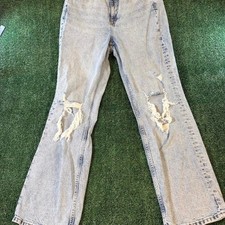 H&M Divided high-waisted distressed jeans in a light acid wash denim featuring picture
