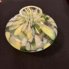 This item is a collectible art glass featuring a green and white swirl design. picture