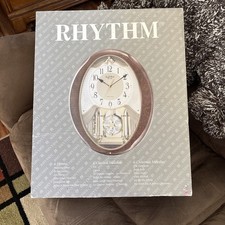 Rhythm Small World 4MJ899WD23 Wood Grain Clock Musical 18 Melodies picture