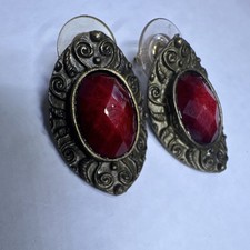 vintage statement earrings feature deep red oval center stones framed by bronze picture