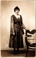 Postcard Real Photo RPPC Young Woman in Black Standing Next to Chair picture
